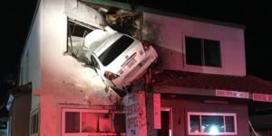 Car crashing though second story of building