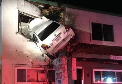 Car crashing though second story of building